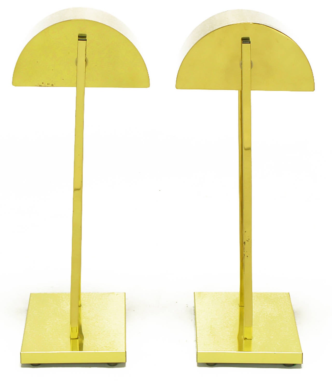 Unusual pair of Kovacs lighting brass desk top table lamps with brass demilune shades after Walter Von Nessen. Shades are supported by two brass square bar uprights and have a brass rod stop on the side that enables them to swivel 45 degrees. Heavy