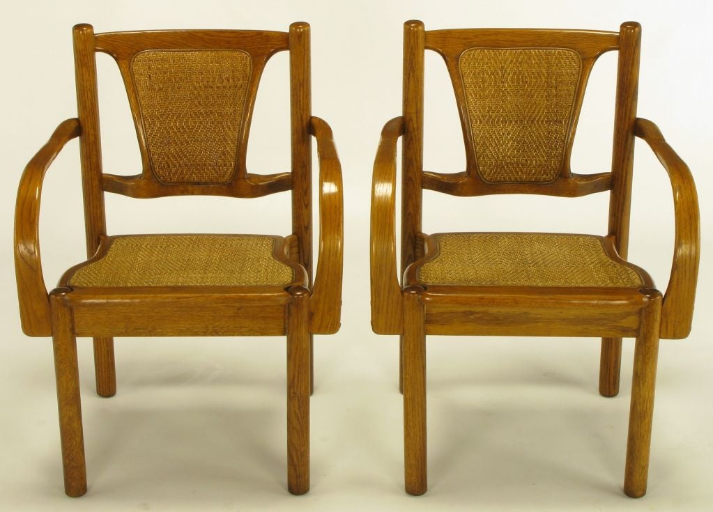 Well made and uncommon oak arm chairs with basket weave seats and backs after Michael Thonet and Kohn Mundus. Not a single straight cut on these oak chairs with sculpted arms, seats and backs.