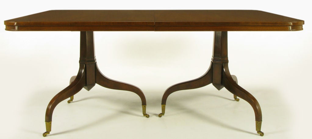 Kittinger of Buffalo, NY mahogany dining table with radiused corners and an incised top border. A modern derivation of the Georgian style, double pedestal bases with 