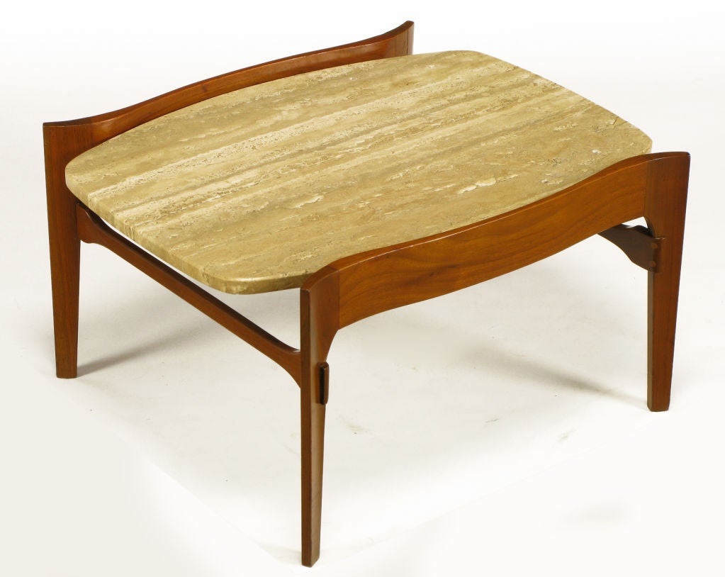 Excellent walnut and travertine end table often attributed to Bertha Schaefer but actually manufactered in the USA by Gordons Inc. Serpentine carved wood sides with canted legs and paddle end stretchers. Second half tier is removable, allowing use