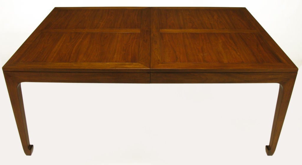 Fiqured walnut parquetry top dining table, possibly designed by Michael Taylor for Bakers Far East collection. Four figured walnut panels with offset grained borders. Incised apron and tapered Ming-style legs. Available with factory installed