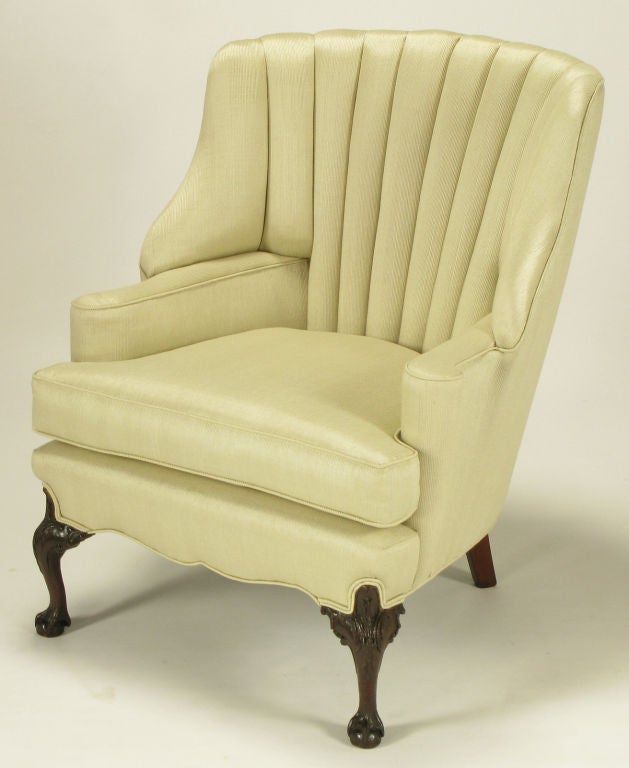 Restored barrel and channeled back regency wide wing chair. New silk upholstery with tactile all vertical pin striping. Rolled end arms with sinuous front apron and heavily carved mahogany ball & claw front legs. Uncommon front roll to the deepset