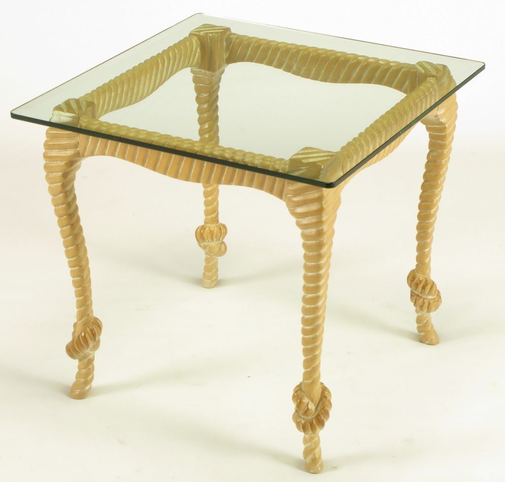 Carved and limed light wood end table with ribbed and knotted rope like legs and lowered apron. Half inch thick square glass top.