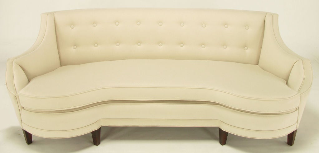 Elegant American art deco sofa restored from the frame up. New cotton padding, jute, cushion and upholstery. Heavily built, with quality comparable to early Dunbar. Curved front and back with half round sides. Swagged and inward curved arms rise to