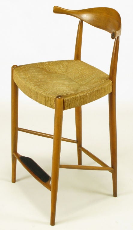 Well crafted and designed counter height bar stool in teak wood frame and original rush woven seat. Black rubber tread on footrest. Similar to the