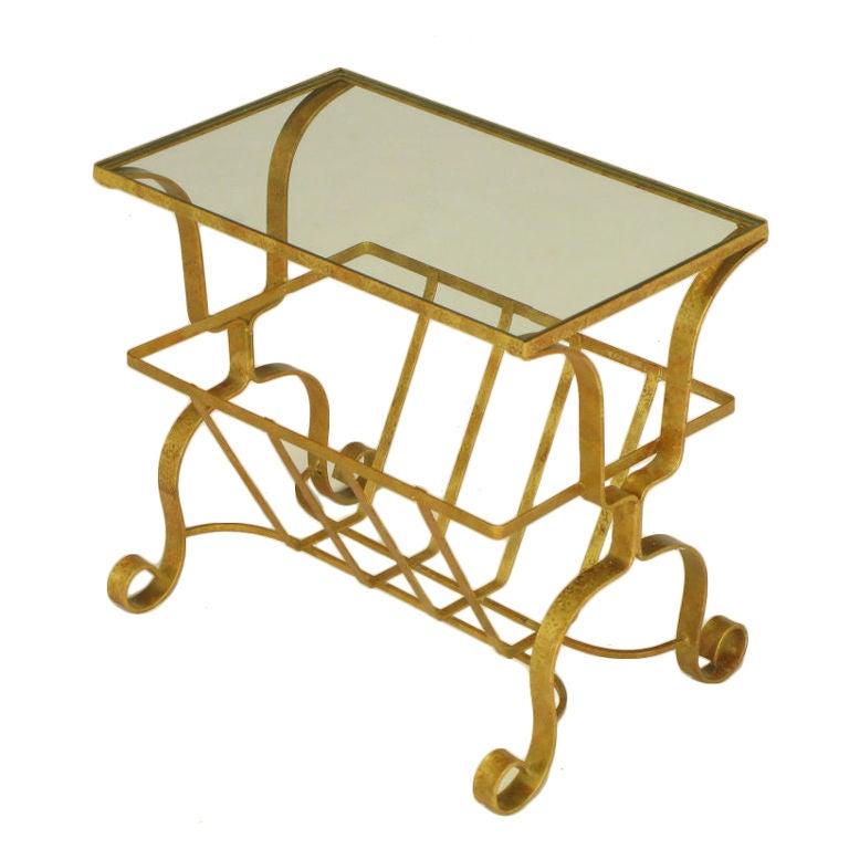 Gilt finished wrought iron and glass side table with curled feet and magazine or towel caddy. Great powder room table or nightstand.