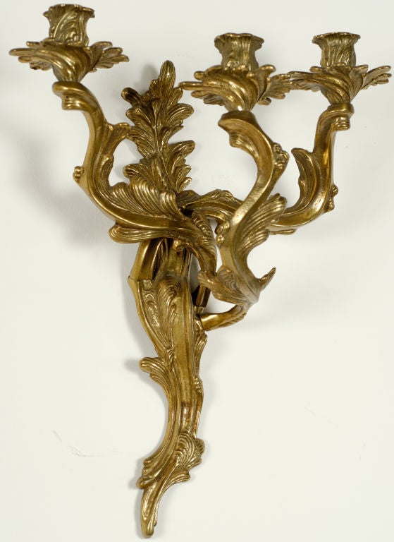 Cast in bronze, and styled in the manner of the Louis XV period well made pair of hanging candelabra or wall sconces. Made by Glo-Mar Art Works of NY