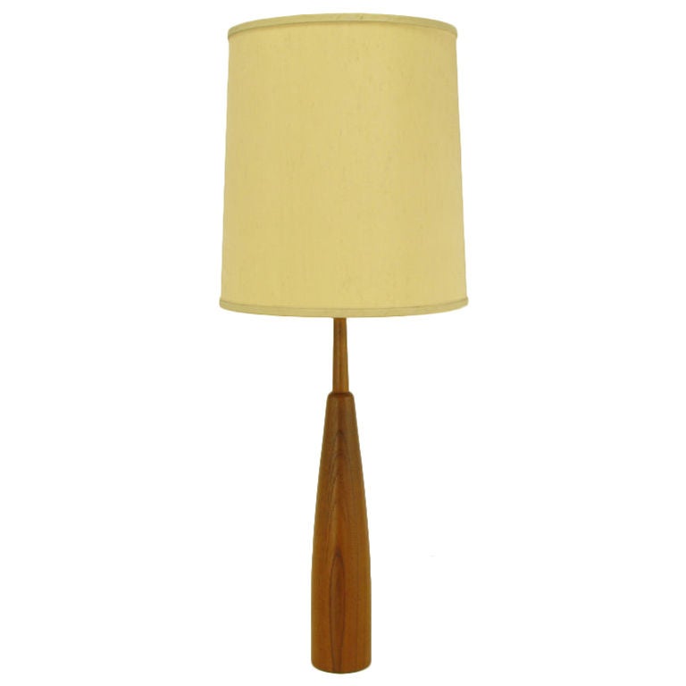 Very finely constructed teak wood table lamp. Solid teak wood body is bottle shaped with a teak wood stem. Brass harp and socket. Sold sans shade.