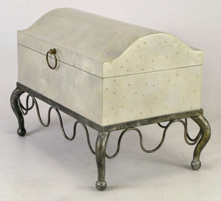Well built and nicely proportioned silver leaf chest on a lacquered wrought iron cabriole legged stand. A brass drop-ring pull lifts the domed top to reveal a black velvet clad interior.