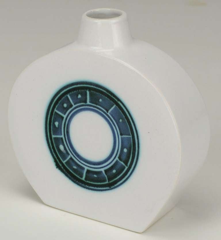 White hand thrown ceramic vase with blue/green and black Celtic inspired relief by Troika Art Pottery.

Troika Art Pottery operated from 1963 to 1983 in Cornwall England by Leslie Illsley, Benny Sirota, and Jan Thompson. They wanted to pursue