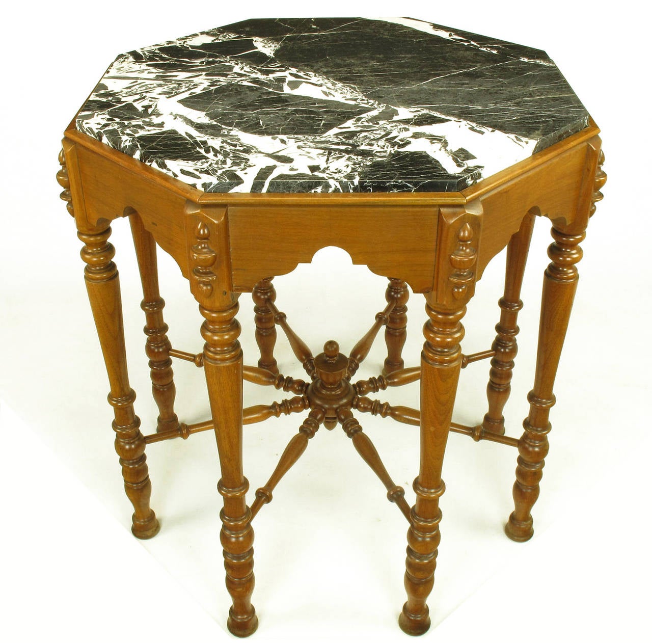 Walnut Eastlake/ Victorian transitional center table or side table with octagonal black and white marble top and eight carved baluster style legs. Ships wheel style center stretcher.