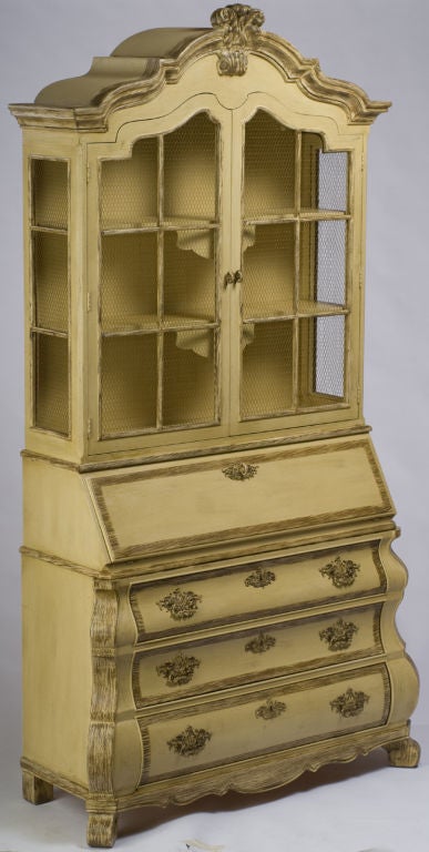 This impressive cabinet was designed by Dorothy Draper for Henredon. It features a Dutch-style bombe base with three drawers, splayed feet, and intricately chased brass drop pulls.<br />
<br />
Above the base is a drop-front secretaire unit, with