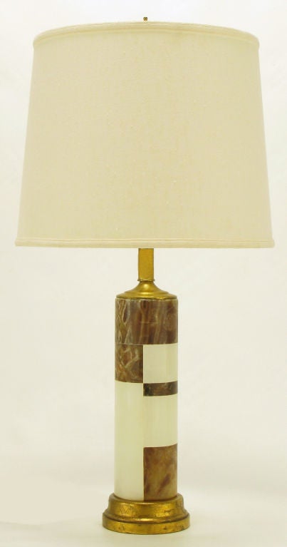 Rouge marble and onyx stone tessellated cylinder table lamp with gilt wood base, cap, and stem in the manner of tables lamps by Hansen. Brass harp and socket.