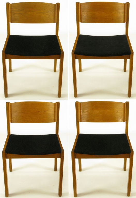 Set of four bleached mahogany frame and bent plywood back dining chairs with new textured black chenille upholstery. Made in West Germany for Harvey Probber, Fall River Mass.