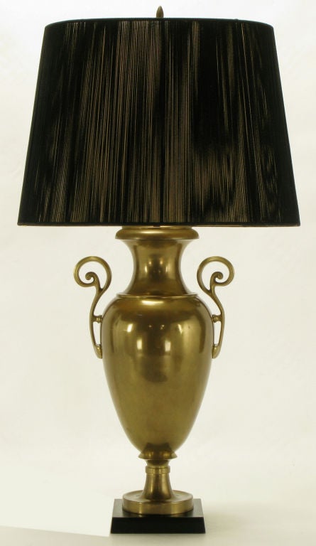 Vintage Chapman lighting urn form table lamp. Solid brass with open fretwork brass handles, and black marble base. Sold sans shade.