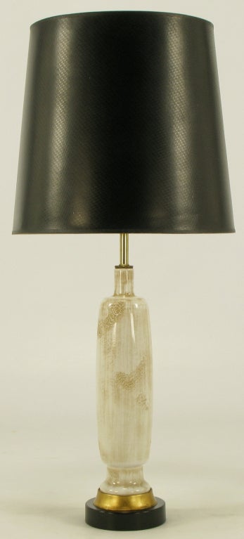 Frederick Cooper ceramic hand thrown & glazed bottle shaped ceramic bodied table lamp. Gilt metal spacer and black lacquered metal base. Ceramic body has a white base glaze with relief and taupe over glaze. Brass stem, harp and socket. Sold sans