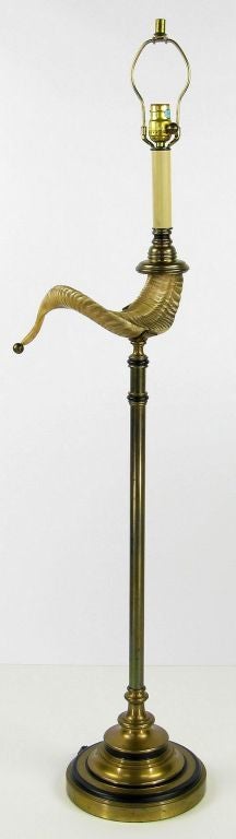 Antique brass and black lacquer base and column cradle a cast ram's horn on this exceptional floor lamp. Complete with harlequin shade.