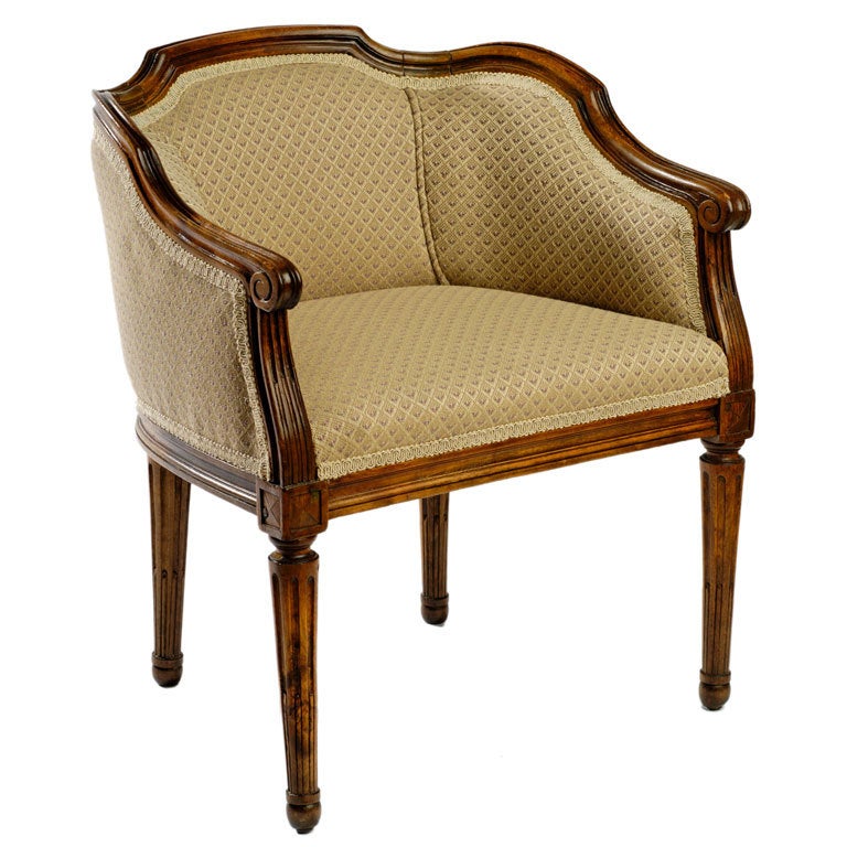 This petite chair was designed for a child's size. It has a hand carved walnut frame, and is upholstered in an ecru fabric with a diamond petit point pattern that includes lavendar accents.