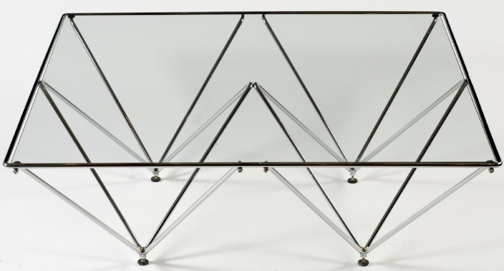Supported by chrome metal structures shaped as inverted pyramids, this table has a clean and light look.  Evocative of a Paolo Piva design, at an affordable price.