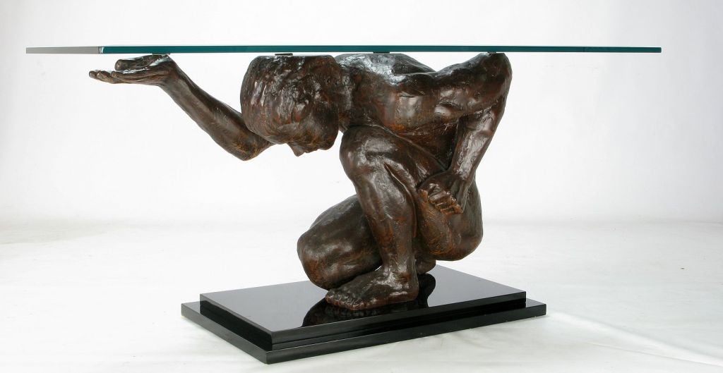 Expertly cast and lacquered bronze finished sculpture of an Atlas-type figure supporting a beveled 1