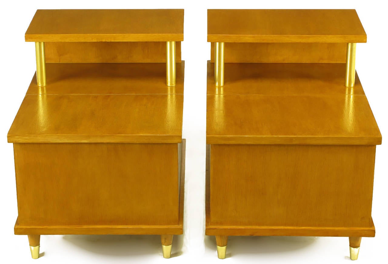 Pair of Lane cedar chest two-tiered end tables. Brushed brass cylinder risers between two tiers and brushed brass sabots. The first tier tops lift up to reveal a cedar lined storage compartment. Stylish and multifunctional extra storage; perfect for