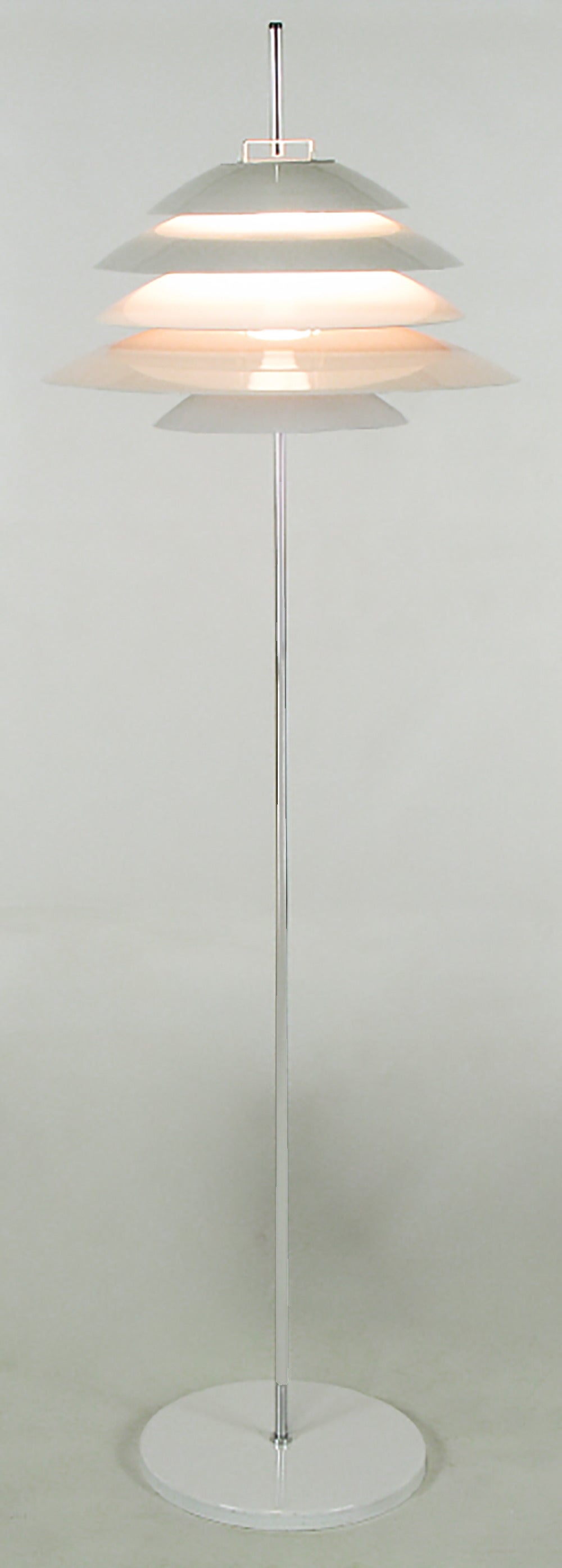 Very sculptural floor lamp by Robert Sonneman. Has layers of white metal shading to baffle the bulb, resulting in very atmospheric lighting.