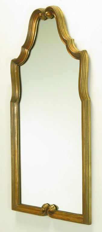 Gilt resin framed wall mirror with top and bottom flourishes and scalloped edge top. Original sold through Turner Manufacturing Co. that began in the late 1800's as a hand carved wall molding and picture frame company in Chicago IL. Ceased as a