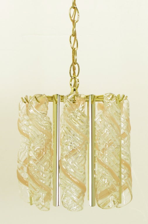 Stunning fixture, composed primarily of clear and pink glass canes fused together into nearly foot-long spirals, separated by narrow brass lacunal panels. Lovely when lighted, or even just in daylight. Perfect for the powder room or in a row down a