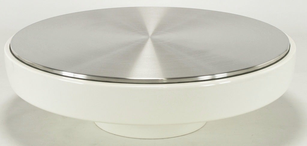 Rare and uncommon fiberglass and stainless steel coffee table by Vecta, a Dallas TX based contract furniture company is now a designer furniture division of Steelcase. This coffee table is constructed of a one piece round white fiberglass body with