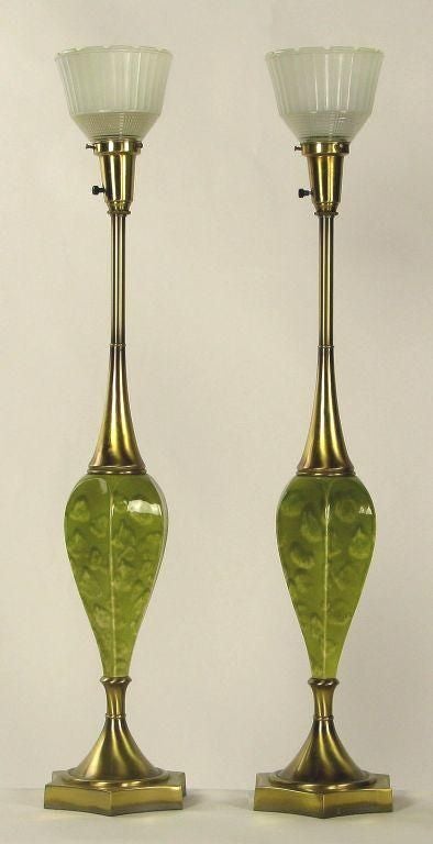 Colorful green lamps, with a green oyster pattern glaze over inverted bulblike pottery. Base and top are antiqued brass, with a trademark Rembrandt holophane style glass diffusers. Sold sans shades.