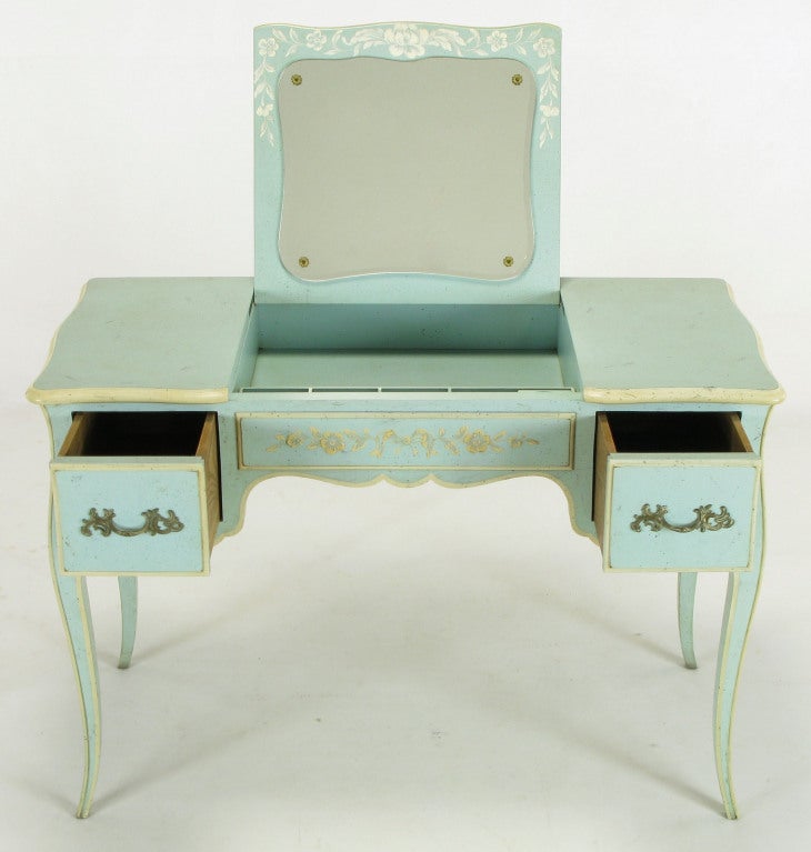 John Widdicomb robin's egg blue & ivory lacquered antiqued flip top vanity. Louis XV style legs, scalloped apron and brass hardware. Ivory hand painted floral detail to the front drawer and side panels. Could also be a stand alone writing table, as