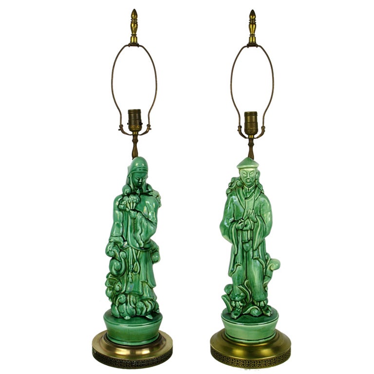These exquisite ceramic Asian figures of a man and woman have been expertly crafted into table lamps. Wonderfully cast and glazed in jade green, with slight and unobtrusive differences in the bases. Sold sans shades