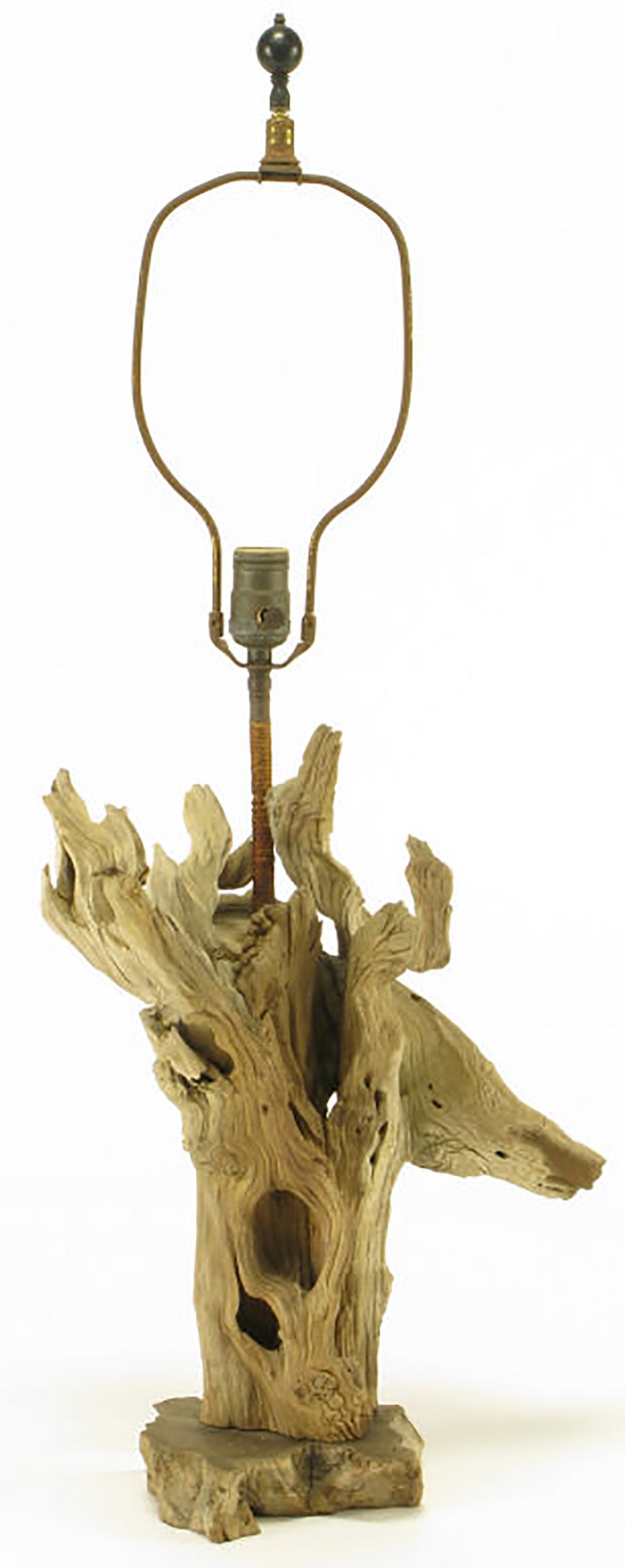 Driftwood table lamp with unexpected live edge carved wood base, circa 1960s. Rush wrapped long stem. Sold sans shade.