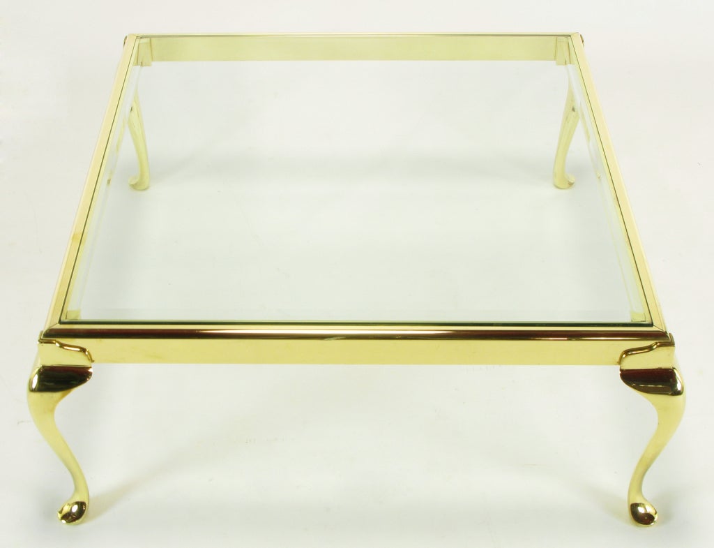 Elegant modern brass coffee table with cabriole legs and a radius top edge frame. Beveled 3/8