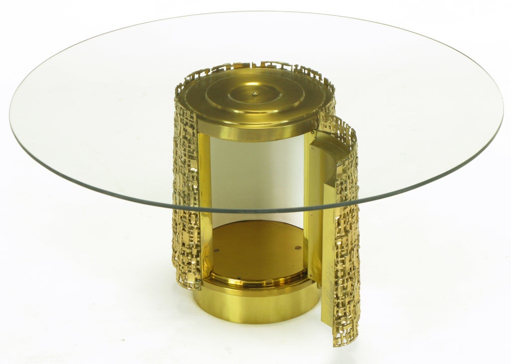 Elegant, one of a kind custom pierced brass pedestal base coffee table in the manner of Silas Seandel. Cast brass quarter round panels encircle the brass clad center wood cylinder. Concealed keyed and hinged door open to reveal simulated calf