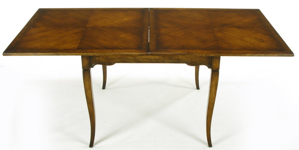Louis XV style walnut flip top game table finished in an aged walnut by the venerable fine furniture maker Old Colony, a peer of Charak Furniture and H. Sacks. All three were located in Boston. Book matched parquetry inlay to both sides of the flip