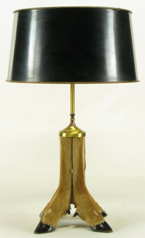 Four leg and hoofed table lamp base made from taxidermy natural fur white tail deer legs. The four legs join together at the center column and are capped by a brass cup with brass stem and double socket brass cluster. See our listings for an similar