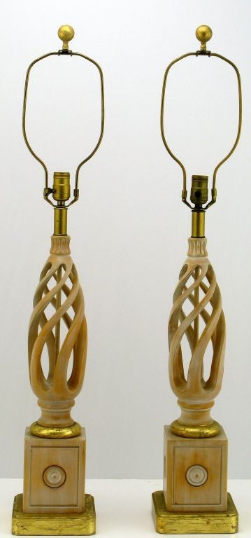 These early Fredrick Cooper table lamps are a wonderful example of classic American form, with open barley twist columns. The carved two piece body is perched on a solid wood base with gilt appointments. Sold sans shades.