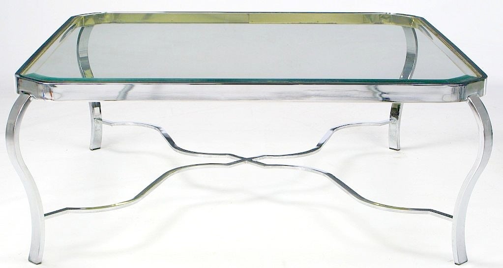 Quite possibly Milo Baughman, this coffee table has a neoclassic design combined with the metals of choice for the 1970s. Chromed cabriole legs, brass trim as well as a stylized X-form support allow for many interior applications.