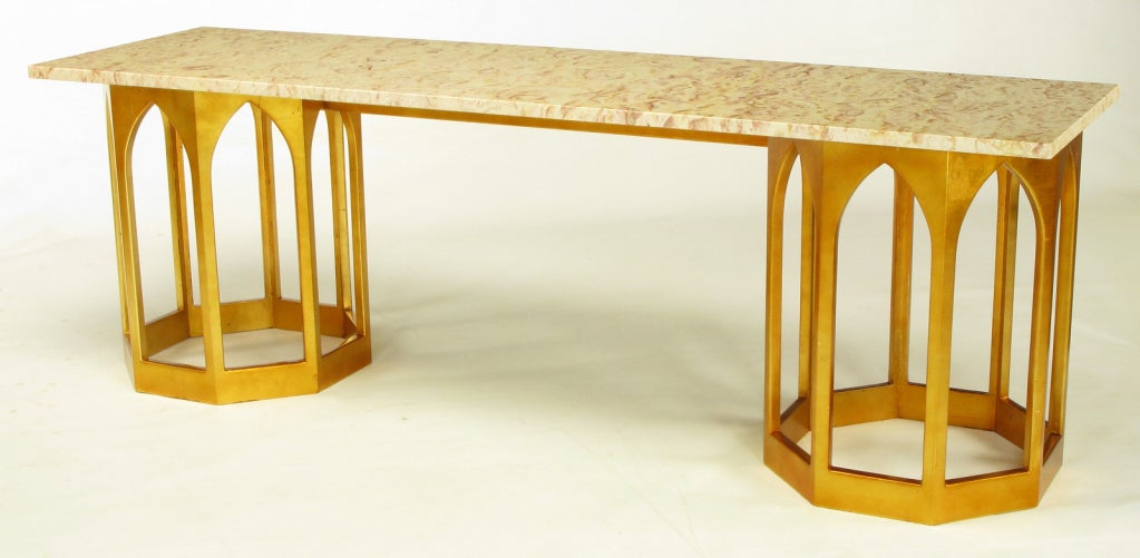 Gilt wood double hexagon console table with cathedral style openings and center stretcher. Cream marble with rose and salmon color veining and ochre undertones. Would also make an uncommon sofa table. Similar to designs by Harvey Probber