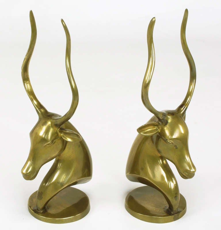 Classic art deco antelope head brass sculptures, which may be used as bookends. Semi-hollow with round plinth base.