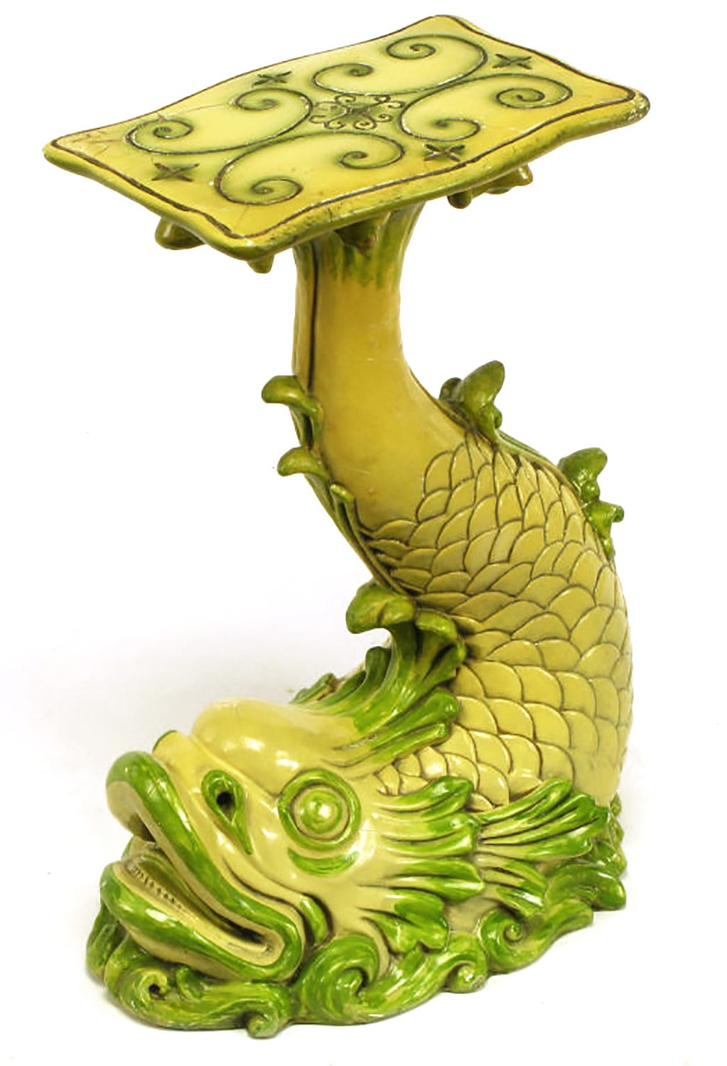 Classic French Regency dolphin pedestal table made from cast resin and glazed in the manner of ceramic pottery. The resin has been finished with gesso and then glazed with a saffron yellow and moss green high gloss finish. Original finish, shows