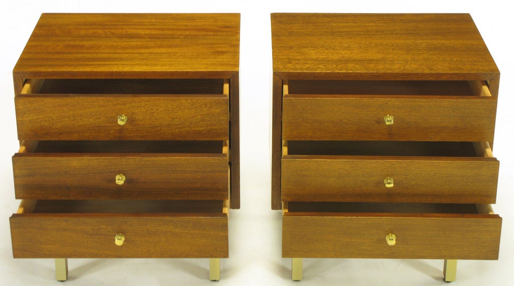 Excellent pair of figured mahogany and brass nightstands with front and side wood stretchers by American of Martinsville. 
Simple brass pulls to three drawers.  Mahogany and brass legs supporting square design of the three drawer cabinets.