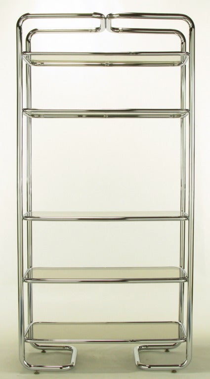 Soft rounded corners and chromed tubular steel etagere in the manner of John Mascheroni. Five shelves with inset smoked glass. Unusual return sled base.