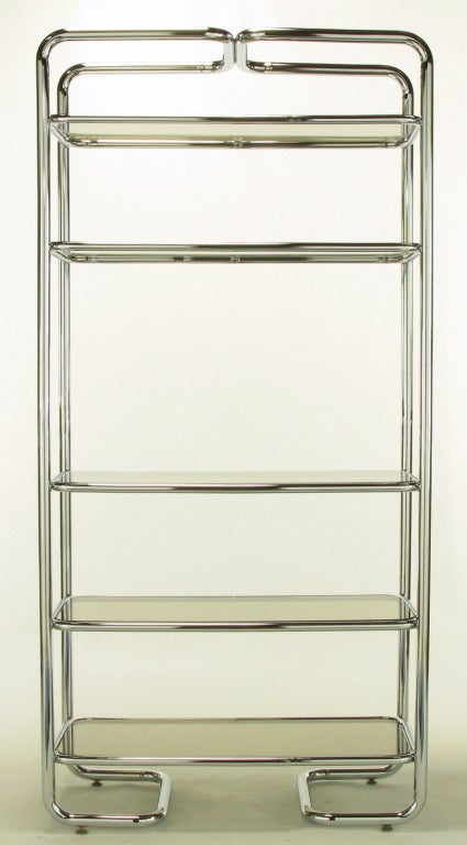 Soft rounded corners and chromed tubular steel etagere in the manner of John Mascheroni. Five shelves with inset smoked glass. Unusual return sled base.