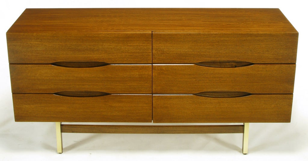 Clean lined six drawer dresser form American of Martinsville. Elliptical inset drawer openings and four brass clad mahogany deeply recessed legs with high set mahogany stretchers.