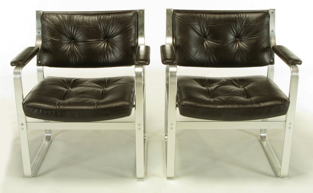 Pair of Mondo arm chairs designed by Karl-Erik Ekselius (1914-1998) for J.O. Carlsson Mobler Vetlanda, Sweden. Polished aluminum frames with dark chocolate leather button tufted seats and backs.