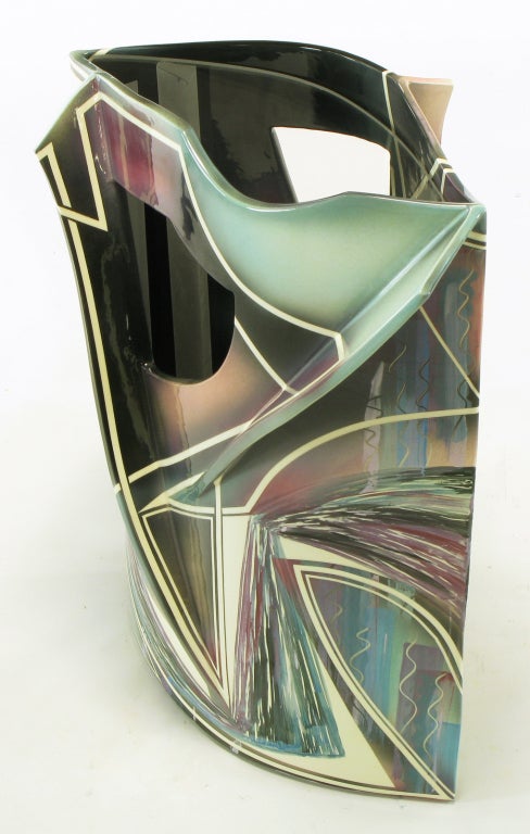 Elliptical shaped ceramic pierced and finned side table with abstract glazed stripes and shapes. Turquoise, magenta, white and black colors glazed in a fluid motion. Glass inset surface. Would also make a striking pedestal. Signed and numbered,