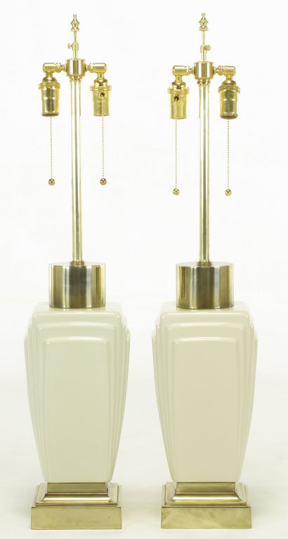 Heavy and well made Stiffel art deco revival table lamps. Cast brass plinth base and art deco inspired ceramic squared and stepped ceramic body. Round Brass cylinder cap with new stems and new double socket clusters. Sold sans shades.