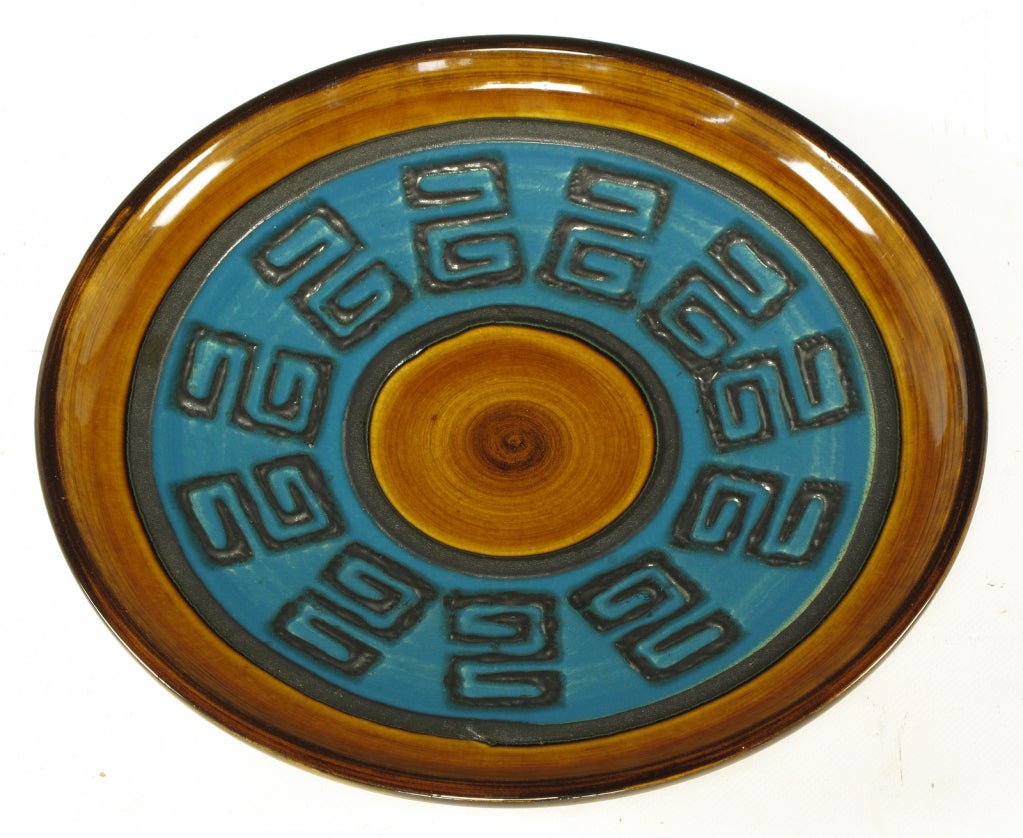 West German ceramic wall plate or charger. Crisp glaze and Greek key center pattern with caramel and blue glaze alternating circles. Nice lava relief to the Greek key detail.